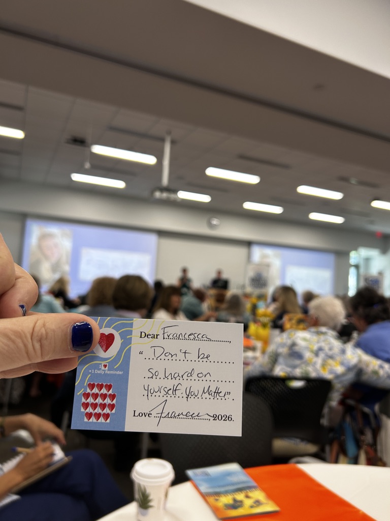 An attendee holds their Sophie-inspired card at the summit, with the message: Don’t be so hard on yourself. You matter.