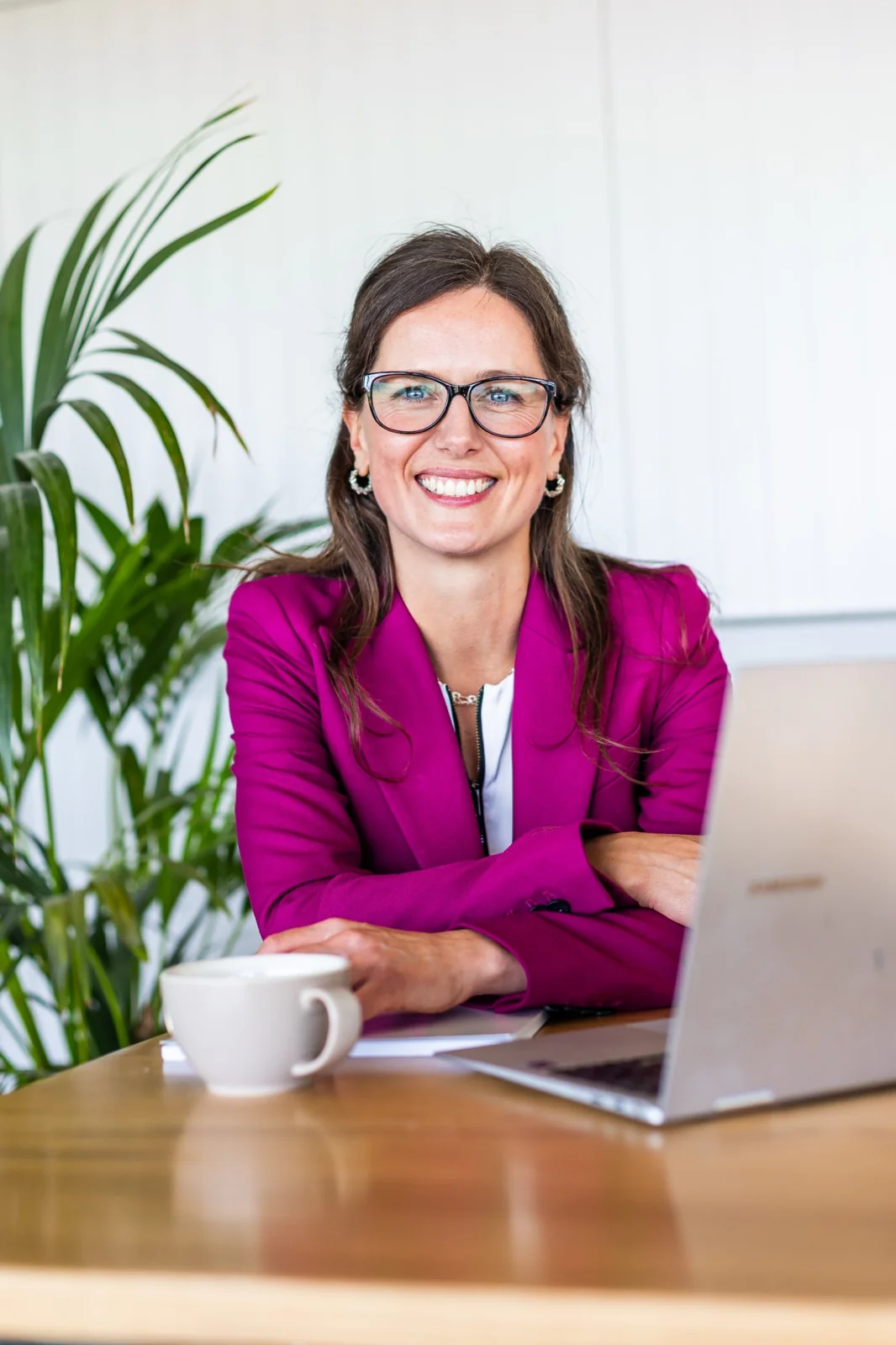 Sally smiling towards the camera at her desk